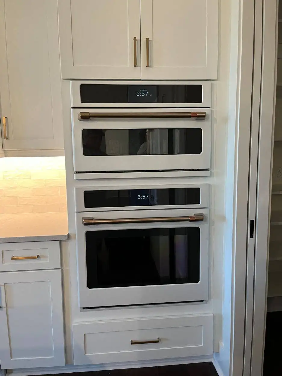 White Café double wall oven with gold handles installed in white cabinetry