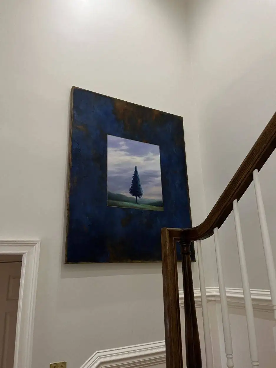 The pine tree painting installed in the stairwell.