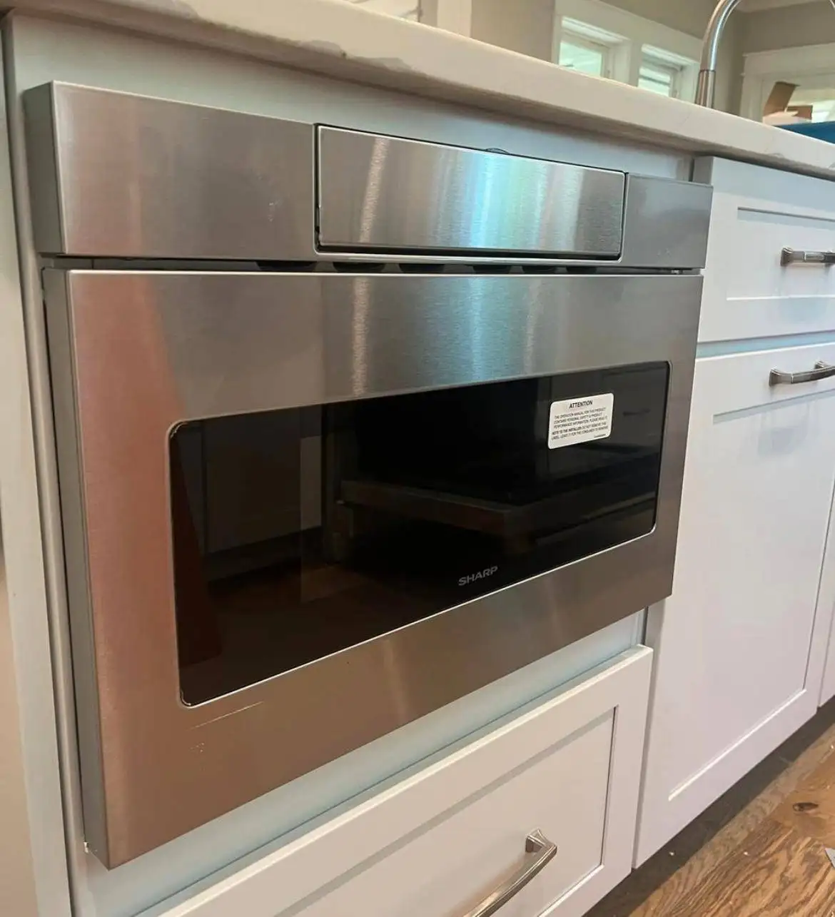 Built-in microwave installed in the kitchen cabinet.