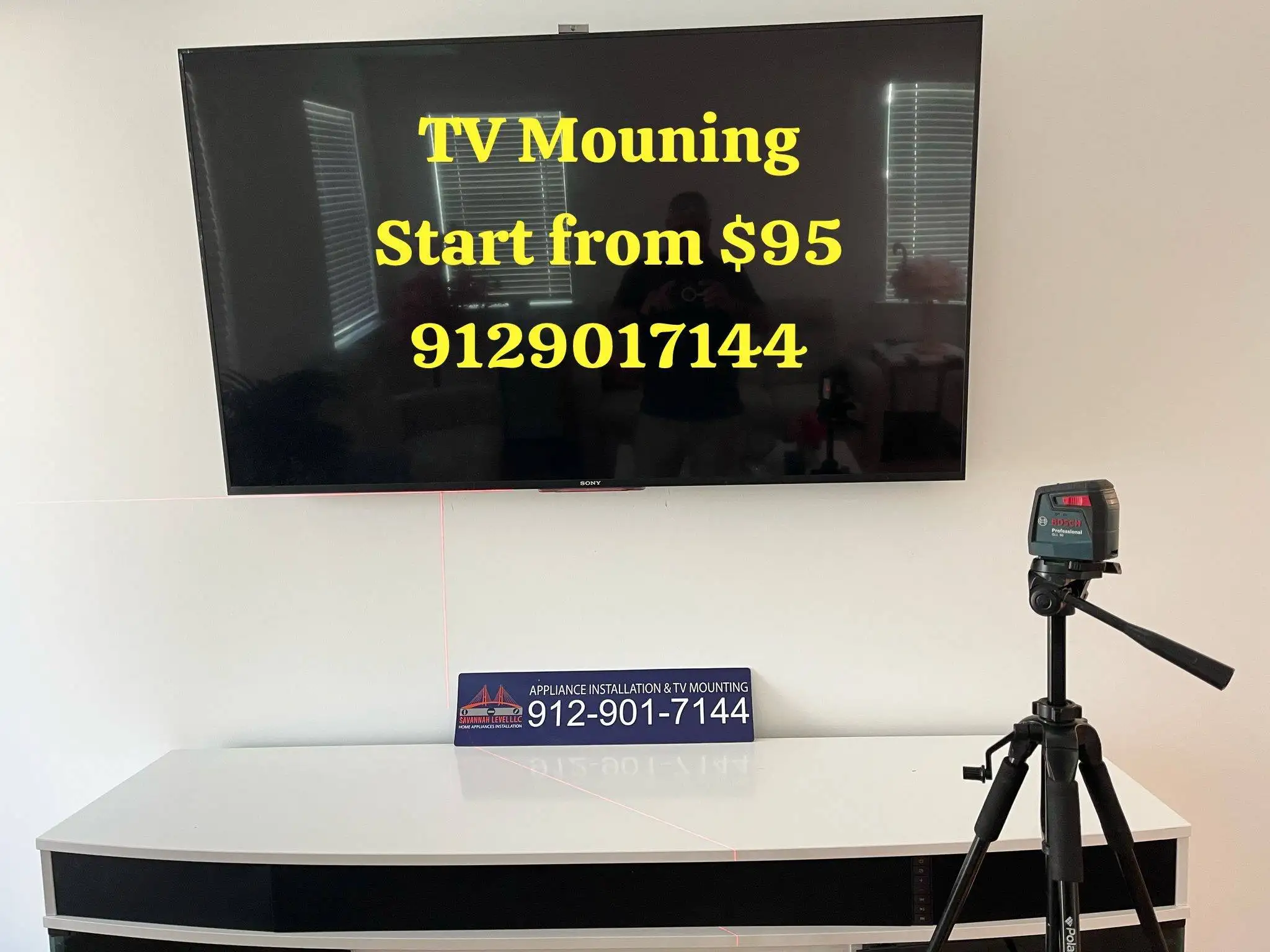 Sony TV wall-mounted and aligned straight with a laser level on a tripod