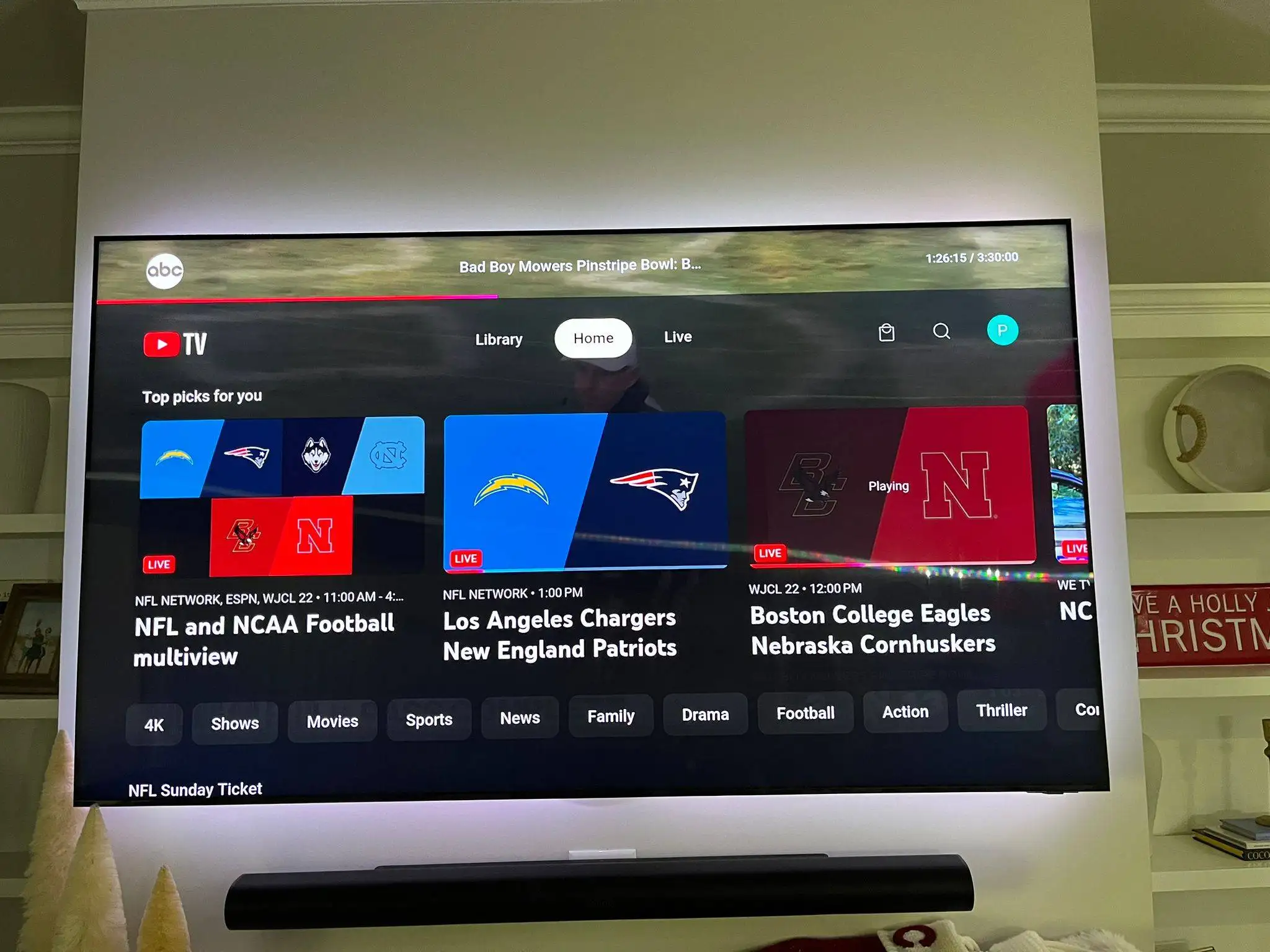 Flat-screen TV mounted on a built-in wall displaying a streaming home screen